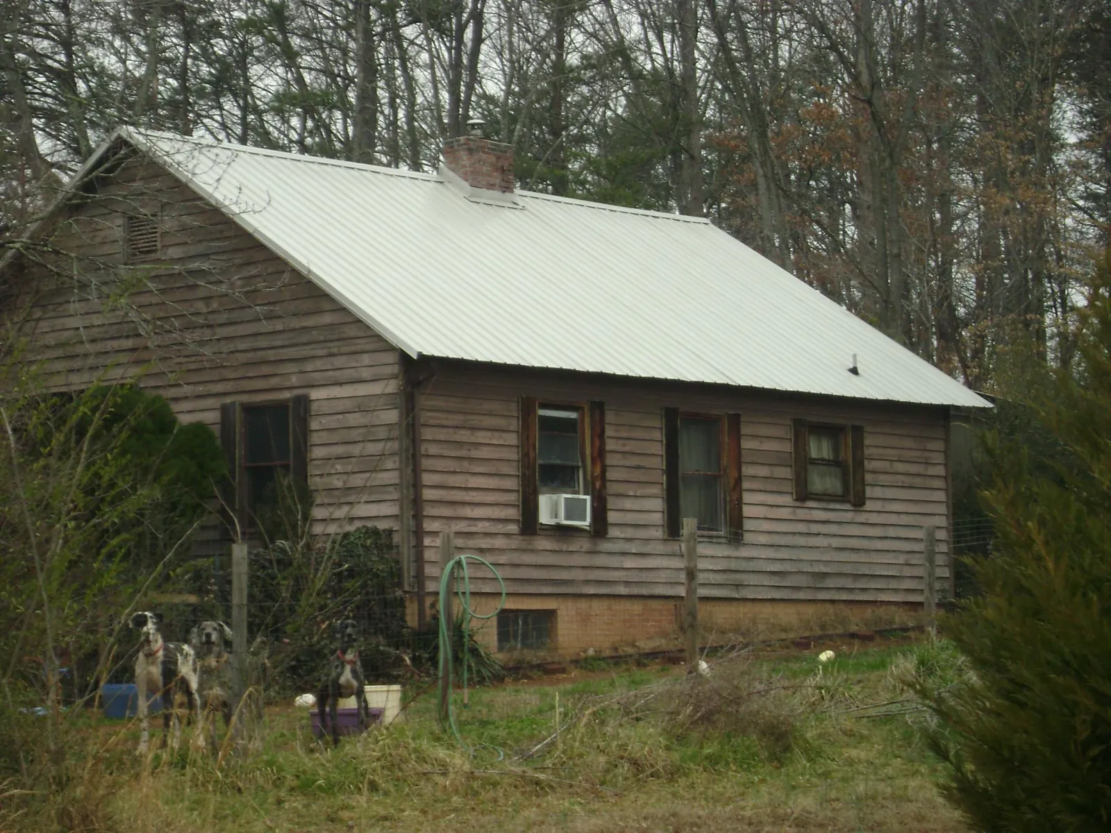 White metal roof on an old wood sided farmhouse, from a Metal Roof Installation job in North Babylon